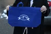 Palmer City Councilwoman Linda Combs displays a blue mesh reusable grocery bags with a picture of Palmer’s water tower on it. This bag is an alternative to disposable plastic bags, which are 
