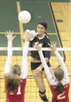 JEREMIAH BARTZ/Frontiersman Colony junior Mary Klapperich gets
above the block of Wasilla’s Jolee Fife, left, and Kayla Binggeli
during a loss to the Warriors Tuesday.