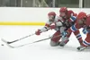 Wasilla sophomore Colton Fletcher holds off two East High Thunderbirds as he reaches for the puck in a game against East Anchorage during the 2012-13 season. Fletcher has been selected by the