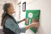 Trinity Lutheran Church Pastor Diane Krauszer fixes a work of art that is part of the Scriptural Way of the Cross at the church. There are 14 displays in all, created by church congregants an
