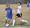 Palmer's Haley Hanson (left) looks to possess the ball before Nikiski's Verity Feltman boots it Friday at Nikiski High School. Joey Klecka/Peninsula Clarion