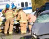 ROBERT DeBERRY/Frontiersman Mat-Su Central rescue personnel tend
to a victim of a two-car collision along the Palmer-Wasilla Highway
near Mayflower Court on Monday afternoon. Central Mat-Su F