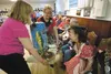Paws and Taws member Mary Jones checks out one of the pie packages up for auction at the Paws and Taws Pie Auction Saturday at the Salvation Army in Palmer. ROBERT DeBERRY/Frontiersman.com