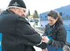 Robert Monroe gets an autograph from Wasilla musher Karin Hendrickson before the restart of the 2013 Iditarod Trail Sled Dog Race Sunday on Willow Lake. ROBERT DeBERRY/Frontiersman.com