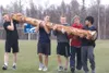 ROBERT DeBERRY/Frontiersman Members of the Palmer High School
wrestling team carry a log across the school’s athletic field
Monday afternoon as part of their training.