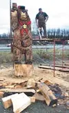 Carver Tom Robertson stands on a scaffold he used to carve the
12-foot tall bear. Photo by CASEY RESSLER/Fronteirsman.