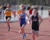 Houston's Allison VanPelt leads a group of runners down the track in the girls' 100 meter event during the Wasilla Warrior Track Mania single-day meet Friday afternoon at Wasilla High School.