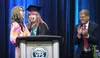Valley Pathways teacher Franchesca Heywood enjoys a moment with graduate Ashlynn Harrison as Mat-Su Borough School District superintendent Dr. Randy Trani applauds during the school's commenc