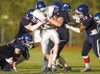 John Wagner/Fairbanks Daily News-Miner Palmer running back David
Clement, center, is brought down by a host of North Pole Patriots
Friday. JOHN WAGNER
