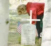 ROBERT DeBERRY/Frontiersman Linda Bergman cleans around the
grave site of her father at Aurora Cemetery in Wasilla Monday
afternoon before the start of the AMVETS Post 11 Memorial Day
service