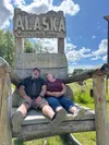 Scott and Joan Thompson sit in the “big chair” in front of Willow Creek Studio. The chair has been one of their biggest attractions since opening the studio, and visitors from all over the wo