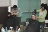 Haircuts were available at this year’s annual Mat-Su Valley Home Connect. At left, stylist Kirk Pierce trims up Nicholas Grippin while at right, Kristen Cucullu puts the finishing touches on 