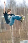 Erin Hogan, 20, takes advantage of the warm spring weather to
execute a trick called an 'indy air' above the concrete half-pipe
at the skatepark Thursday afternoon in Wasilla. (ROBERT
DeBERRY
