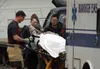 Paramedics load Codey Tallman, 24, of Wasilla, into an ambulance after Tallman was shot by a homeowner in the front yard of a home on Cottonwood Loop on Wednesday, March 30, 2016. Tallman was