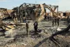 Members of the U.S. military and international media survey the damage of Iranian missile attacks at Al Asad Air Base, Iraq, Jan. 13, 2020. Alaska Air National Guardsmen of 211th Rescue Squad