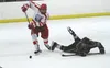 Wasilla forward Garrett Conroy handles a rolling puck as Colony forward Cooper Smith pushes his stick forward after diving to the ice during Wasilla's 4-3 win over Colony in January. Conroy w