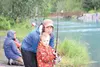 Beck Laboucane, 4, gets a casting lesson from mom Terryll Laboucane while little sister Bridger Laboucane, 2, tries her hand with a toy pole. In the background are Shirley Adams and her daugh