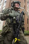 Juneau Police Department Officer Timothy Kissner shares a moment of levity with fellow JPD officers June 9, 2025, at the Juneau capitol building complex during Exercise ORCA 25. The exercise 
