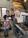 Feather and Flour owner-chef Heather Greenwood, right, and sous chef Meaghan Binkley show off their Something Rotten! promotional material. Photo courtesy of Feather and Flour restaurant