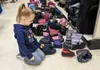 A young shopper checks out the boot selection during the Armed Services YMCA winter clothing giveaway at Fort Wainwright on September 20. Military families were allowed to take a jacket, snow