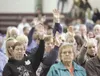 Valley residents raise their hands for a chance to speak at the
meeting, held at the Curtis D. Menard memorial Sports Center In
Wasilla. ROBERT DeBERRY/Frontiersman