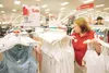 ROBERT DeBERRY/Frontiersman Target associate Jennifer Byars
stocks the clothing section at the Wasilla Target store Saturday
afternoon. Byars said the day’s stocking was heavier following
Bla