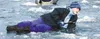 Rachel Kenley of Pioneer Peak Elementary lies on the ice and
jigs shrimp through the ice of Finger Lake Thursday. Photo by CASEY
RESSLER/Frontiersman.