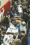 Vendors and customers talk across vending tables Saturday at the 31st Annual Wasilla Gun Show. The event drew more than 200 vendors to the high school, and concludes today at 5 p.m.  BRIAN O’
