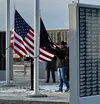 Houston High School seniors Anthony Mazella and Gregory Marano unfurl the POW/MIA flag prior to colors during the Veterans' Day Memorial Wall Ceremony on November 11. Also present were senior