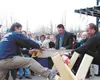 Veteran Iditarod musher Martin Buser and SBS branch manager Joel
Lynch saw through a log wrapped with ribbons at the grand opening
of the Palmer store. This ceremony is a longtime ribbon-cutt