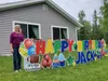 Far North Yard Cards owner Kristin O’Connor stands with a customizable yard card at her home in Wasilla. Jacob Mann/Frontiersman