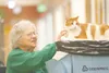 ROBERT DeBERRY/ Frontiersman Dorothy Parker takes a break from
her day to visit Pumpkin, a 12-year resident at the Alaska Pioneer
and Veterans Home in Palmer. The home takes part in the Eden
