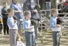 MATT TUNSETH/Frontiersman From left, Tristan Powell, Timothy
Dubin and Hunter Wilkins pause during the singing of the national
anthem at the start of Wasilla Youth Baseball’s opening ceremoni