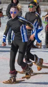 Sigrid Eller, Juneau, takes the baton from Palmer's Jake Black during the start of the second leg of Team Alaska's 4x400m relay 2009 or later mix gold medal performance. J. David McChesney/Fr