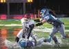 Palmer's James Nisbett and Hayden Niekamp take down East Thunderbird Kevin Luafulu during Friday's ASAA/First National Bowl large-school quarterfinal game at Machetanz Field in Palmer. ROBERT