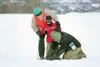Alaska Trails Board member Jack Mosby and Mat-Su Borough Parks
Department employee Warren Templin help Travis Bekkedahl, 6, with
his ski equipment during the Winter Trails Day event near Hatc
