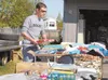 HANNAH GUILLAUME/Frontiersman Palmer resident Jared Carpenter
checks out the goods at a recent Valley garage sale.