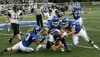 Junior Duston Corbin (13) and senior Parker Smith (50) work to bring down Colony quarterback Eric Christy during a game against the Knights early in the season. Both Corbin and Smith were nam