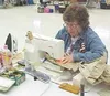 Kathy Buirge sews insignias on battle dress uniforms for
soldiers deploying to Afghanistan. Submitted photo.