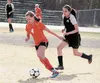 Wasilla freshman Alexa Starr drives the ball away from the defense during a 4-1 win over Colony. Starr netted the hat trick for the Warriors during the victory. JEREMIAH BARTZ/Frontiersman