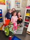 Kaitlyn Pierce, a child-care provider at Sunshine Station Child Care Center in Talkeetna shares some laughs and hugs with students. Courtesy of Sunshine Station Child Care Center