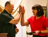 Palmer boys basketball assistant coach Greg Fullmer and Wasilla volleyball head coach Katie Oxspring share a high-five on stage during the Mat-Su Valley Frontiersman/Mat-Su Sea Hawkers Studen
