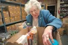 Helenmae Wiederkehr assembles a box of food at the Palmer Food Bank Thursday afternoon. Wiederkehr has volunteered at the food bank for 25 years. ROBERT DeBERRY/Frontiersman.com