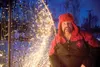 Jeff Mitchell kneels near one of the Christmas light displays at
his house in Victoria Estates. Mitchell, whose Christmas lights are
timed to music, uses his display as a fund-raiser for the 