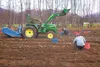 John McNeal uses his tractor to pull potatoes out of the ground Wednesday as volunteers from Bean’s Café and the Alaska Dream Center gather them up. The groups will go home with hundreds of p