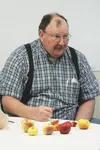 Dan Elliott, of All About Apples, talks about apple cultivation at the seed swap at the Depot Farmer's Market Monday. Elliott handed out apples containing the seeds he brought to exchange. BR