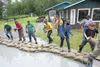 Volunteers with the Butte Fire Department stack sandbags along the edge of the driveway at 1150 N. Old Glenn Hwy. July 23 in an effort to keep the rising Matanuska River from reaching a house