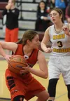 Houston guard Makayla Moore (left) looks for a teammate while Homer defender Rylyn Todd looks on Friday at the Southcentral Conference tournament at Grace Christian High School. Photo by Joey