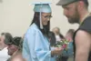 2011 Burchell high School graduate Danielle Goguen hands roses
to members of her family at Monday's ceremony at the Curtis D.
Menard Memorial Sports Center in Wasilla. (ROBERT
DeBERRY/Frontie