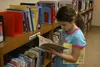 Eight-year-old Saviona Taylor looks through some picture books near the Juvenile Non-fiction section of the Wasilla Public Library on Friday, Nov. 20. Several bookcases down, the 'Government'